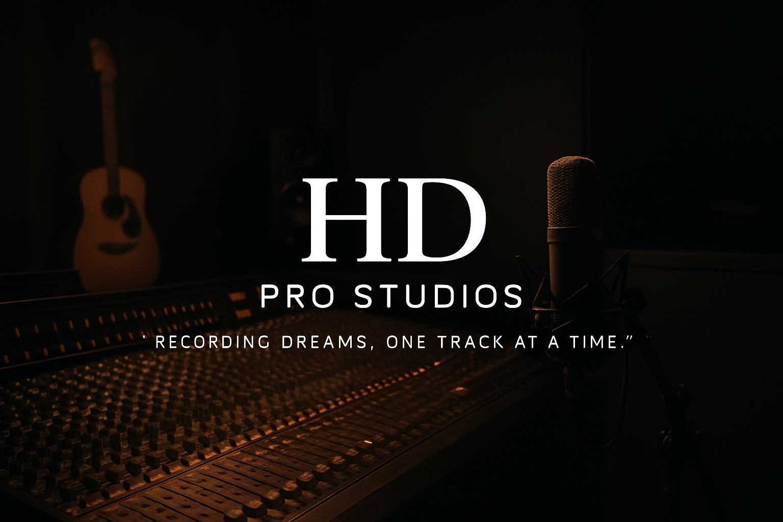 Music recording studio with a microphone on a stand in front of a mixing console, and an acoustic guitar in the background.