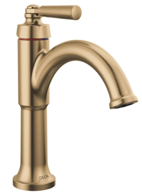 Close-up of a gold kitchen faucet with a curved spout.