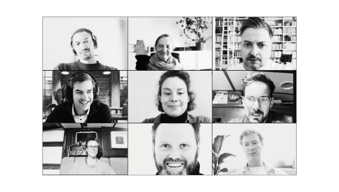 A black and white screenshot of a video conference with nine diverse participants, each in their own environment, smiling or making neutral expressions.