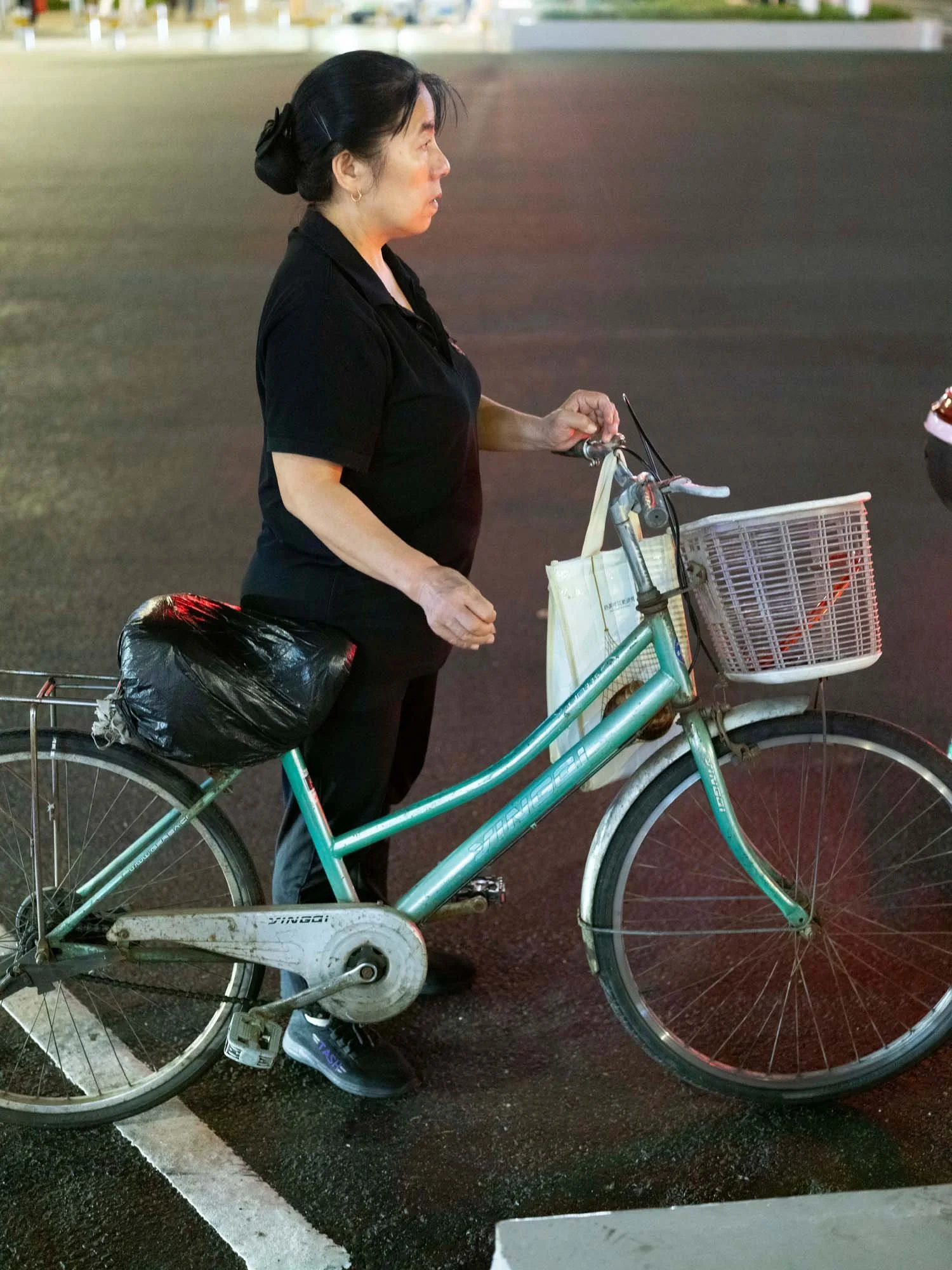 Documentary photograph by Roman Bezjak highlighting Shenzhen as a global leader in e-mobility, showing residents, families, and delivery workers navigating the city on electric scooters.