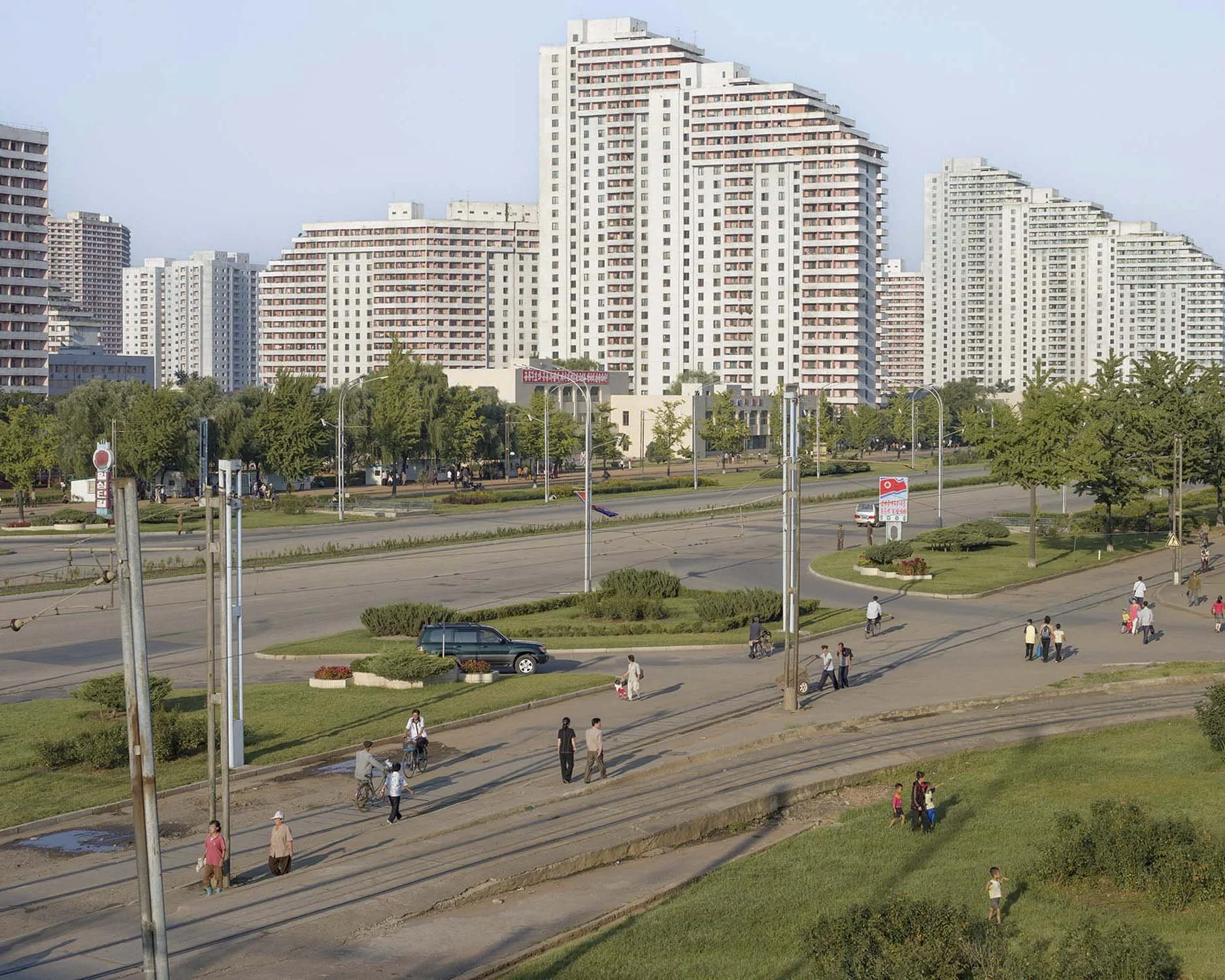 Kwangbok-Straße  in Pjöngjang, Nordkorea: Der weitläufige Boulevard im Südwesten der Stadt zeichnet sich durch seine extrem breiten Fahrspuren, Straßenbahnschienen und die markanten terrassen- sowie weitgefächerten Wohnhochhäuser aus. Die in den spät