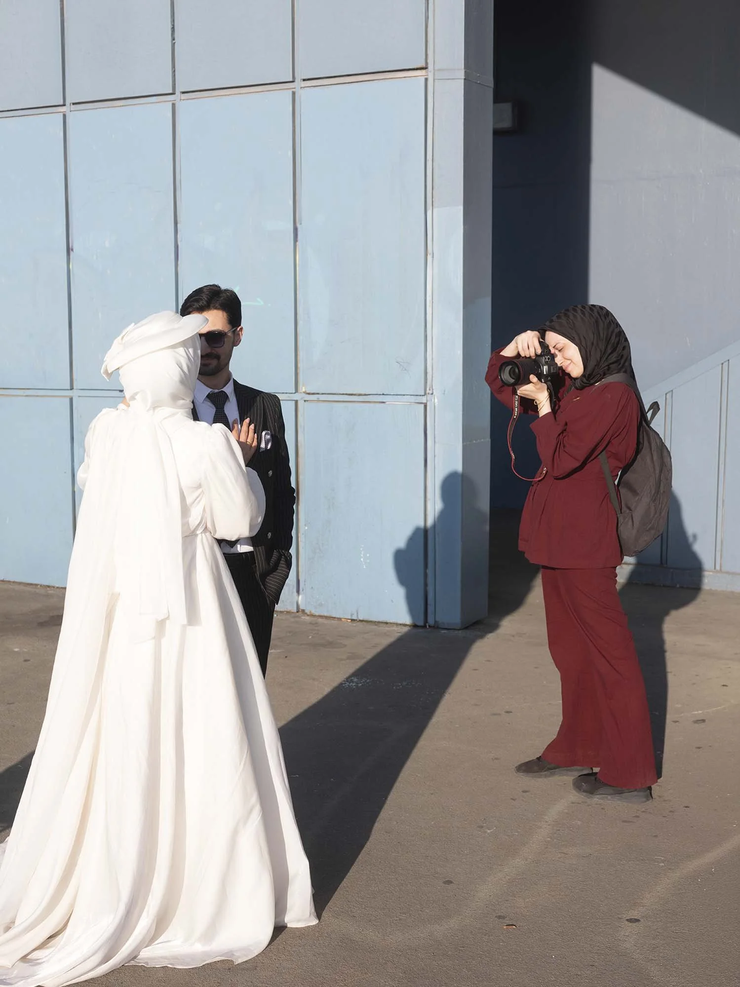 A newlywed couple under the Galata Bridge in Istanbul captured in a documentary photography style by Roman Bezjak