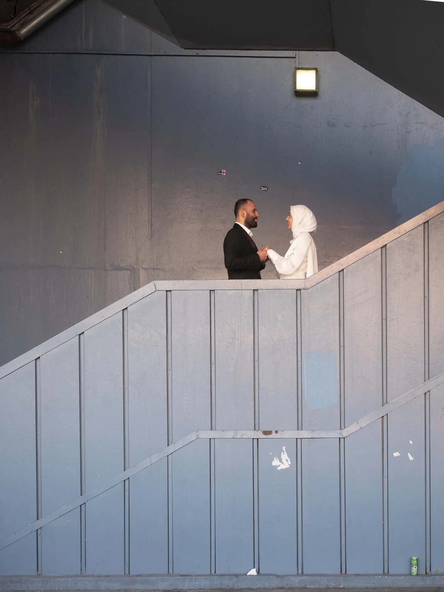 A newlywed couple under the Galata Bridge in Istanbul captured in a documentary photography style by Roman Bezjak