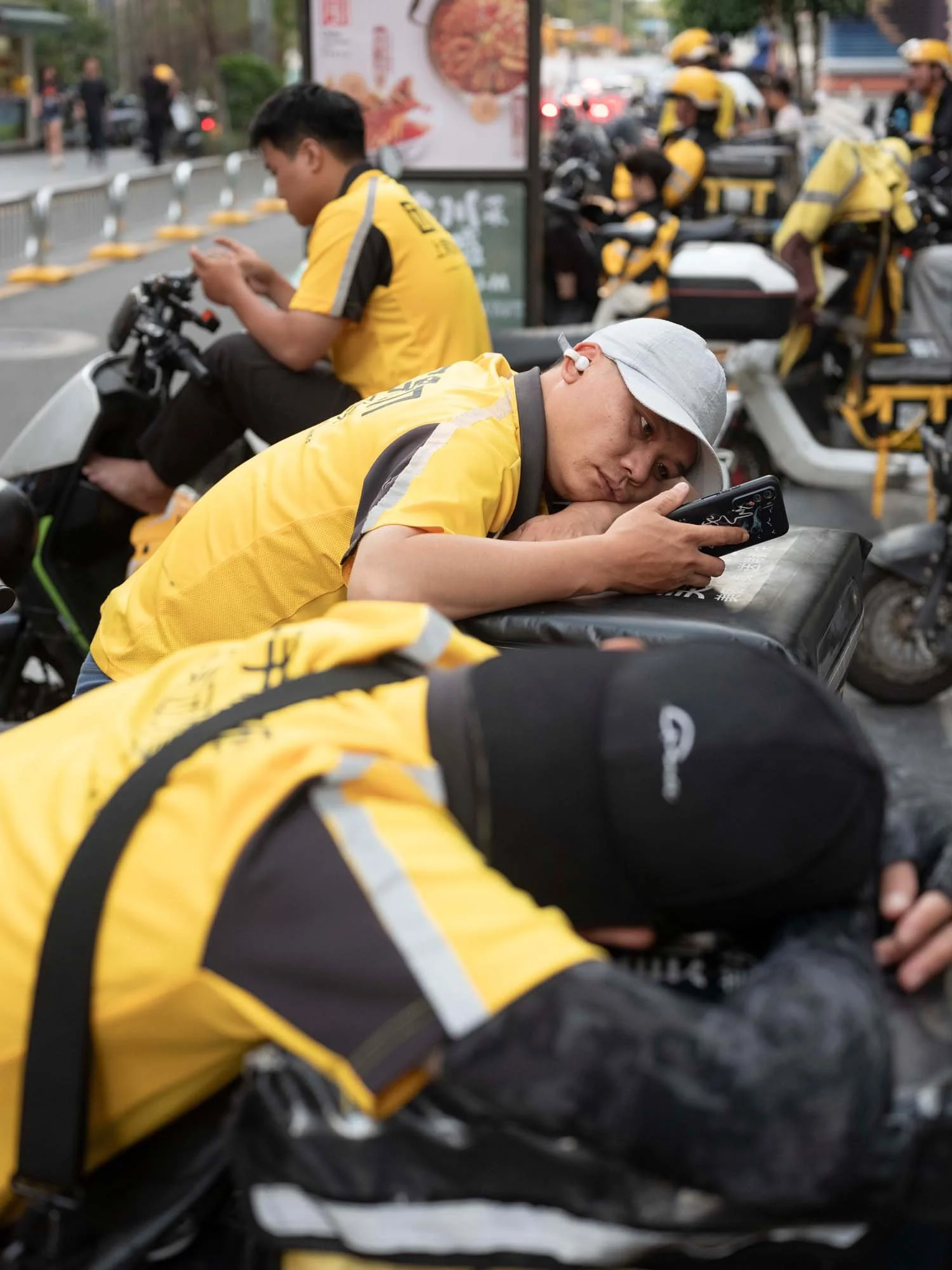 Documentary photograph by Roman Bezjak highlighting Shenzhen as a global leader in e-mobility, showing residents, families, and delivery workers navigating the city on electric scooters.