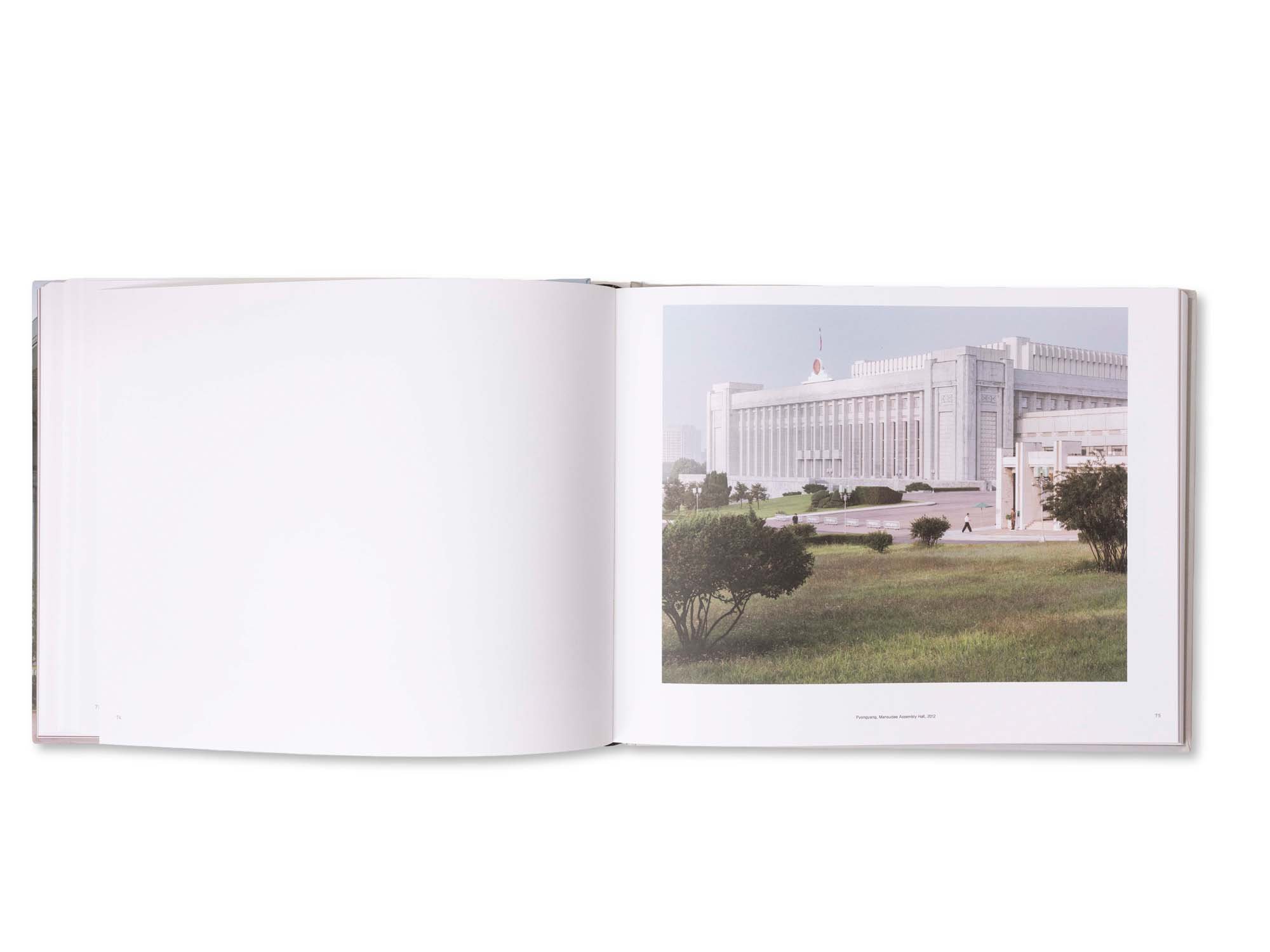 Ein aufgeschlagenes Buch, das eine Fotografie des Jeonguk-Museums zeigt, mit Blick auf das Gebäude vor einem blauen Himmel.
