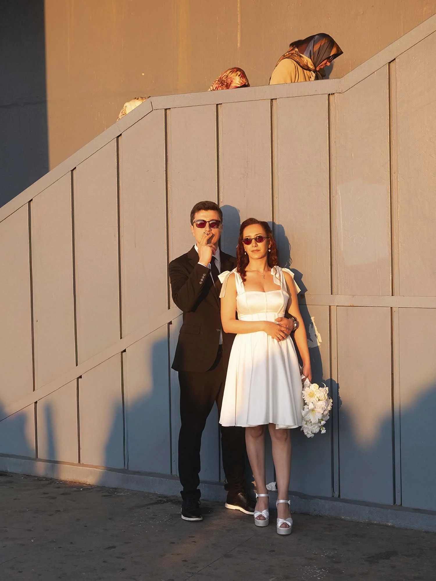 A newlywed couple under the Galata Bridge in Istanbul captured in a documentary photography style by Roman Bezjak