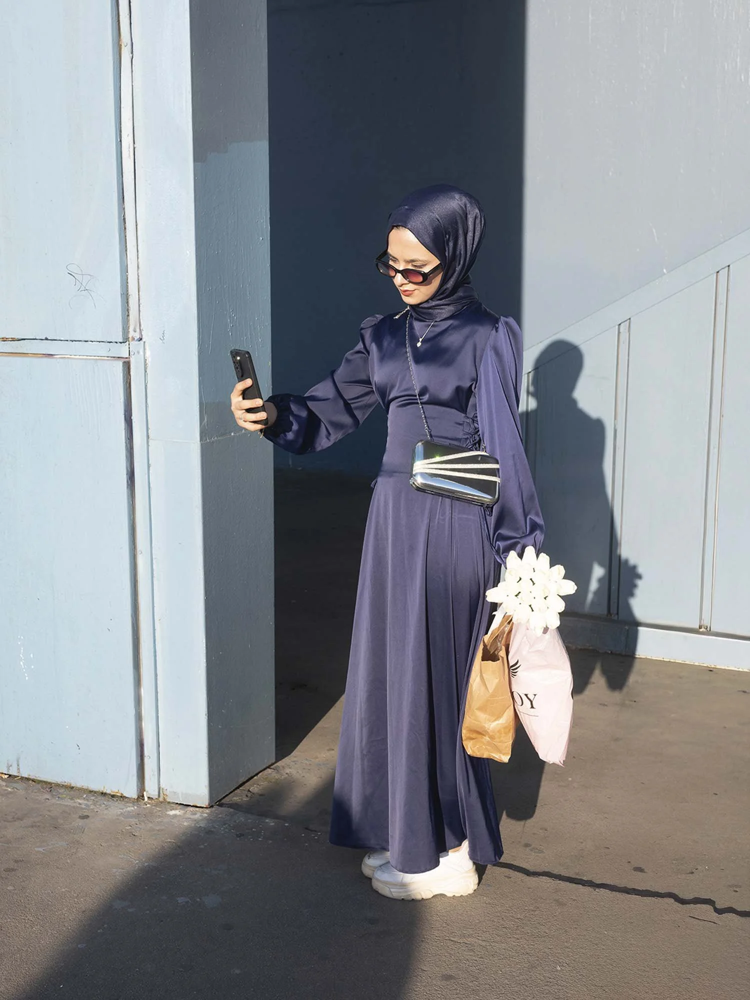 A bridesmaid under the Galata Bridge in Istanbul captured in a documentary photography style by Roman Bezjak