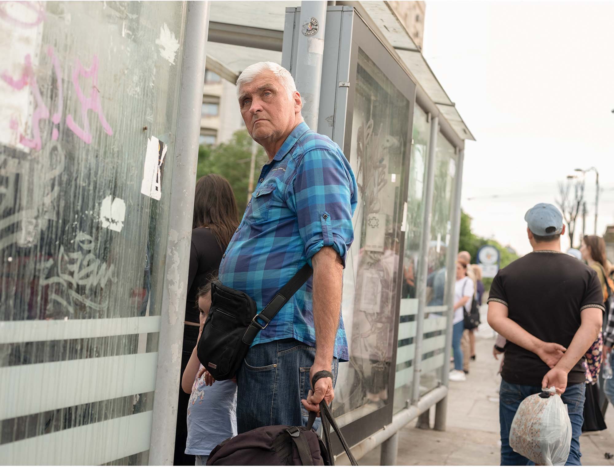 Documentary photo by Roman Bezjak from the series "Bucharest Tram," showing commuters waiting at Piața Unirii