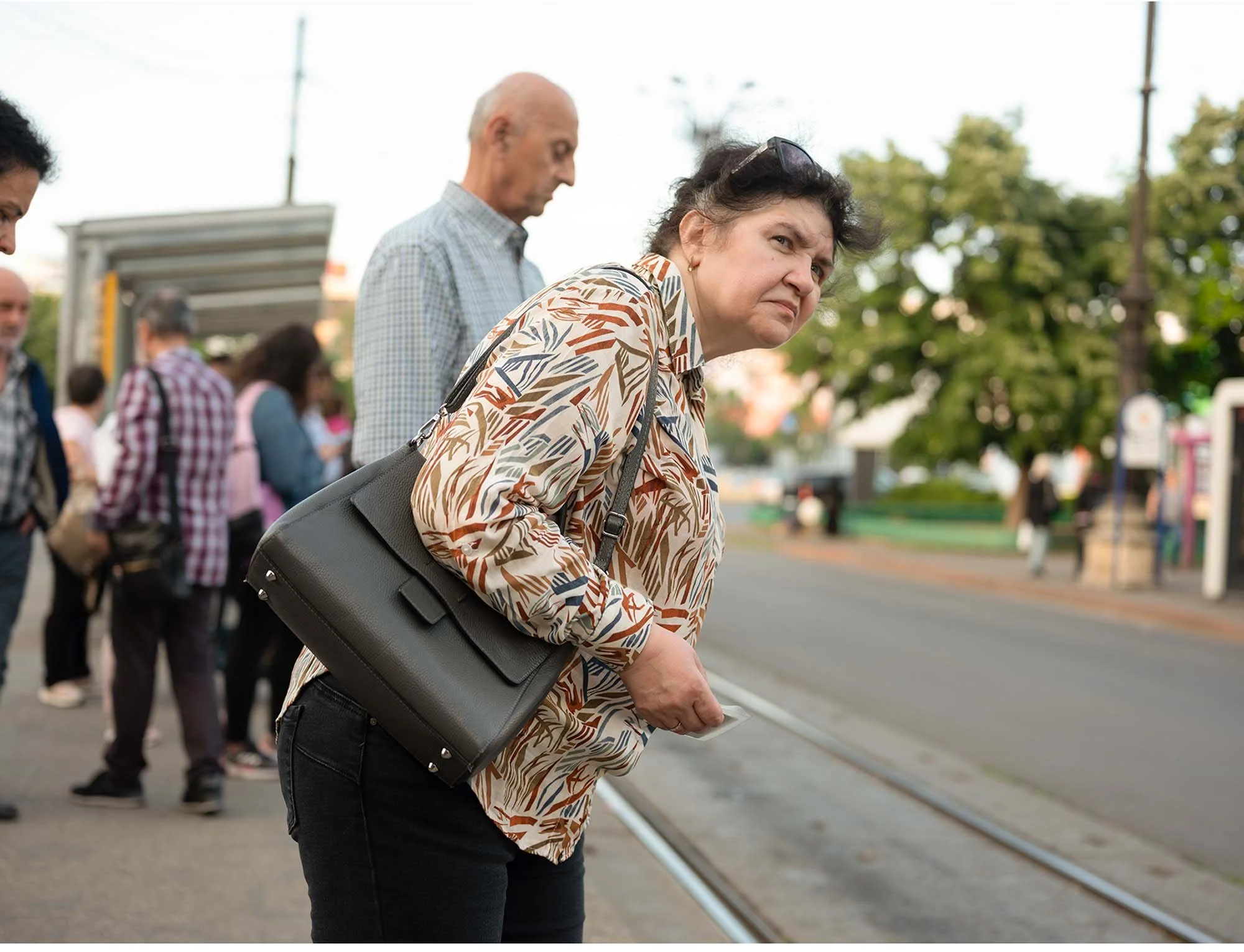 Documentary photo by Roman Bezjak from the series "Bucharest Tram," showing commuters waiting at Piața Unirii
