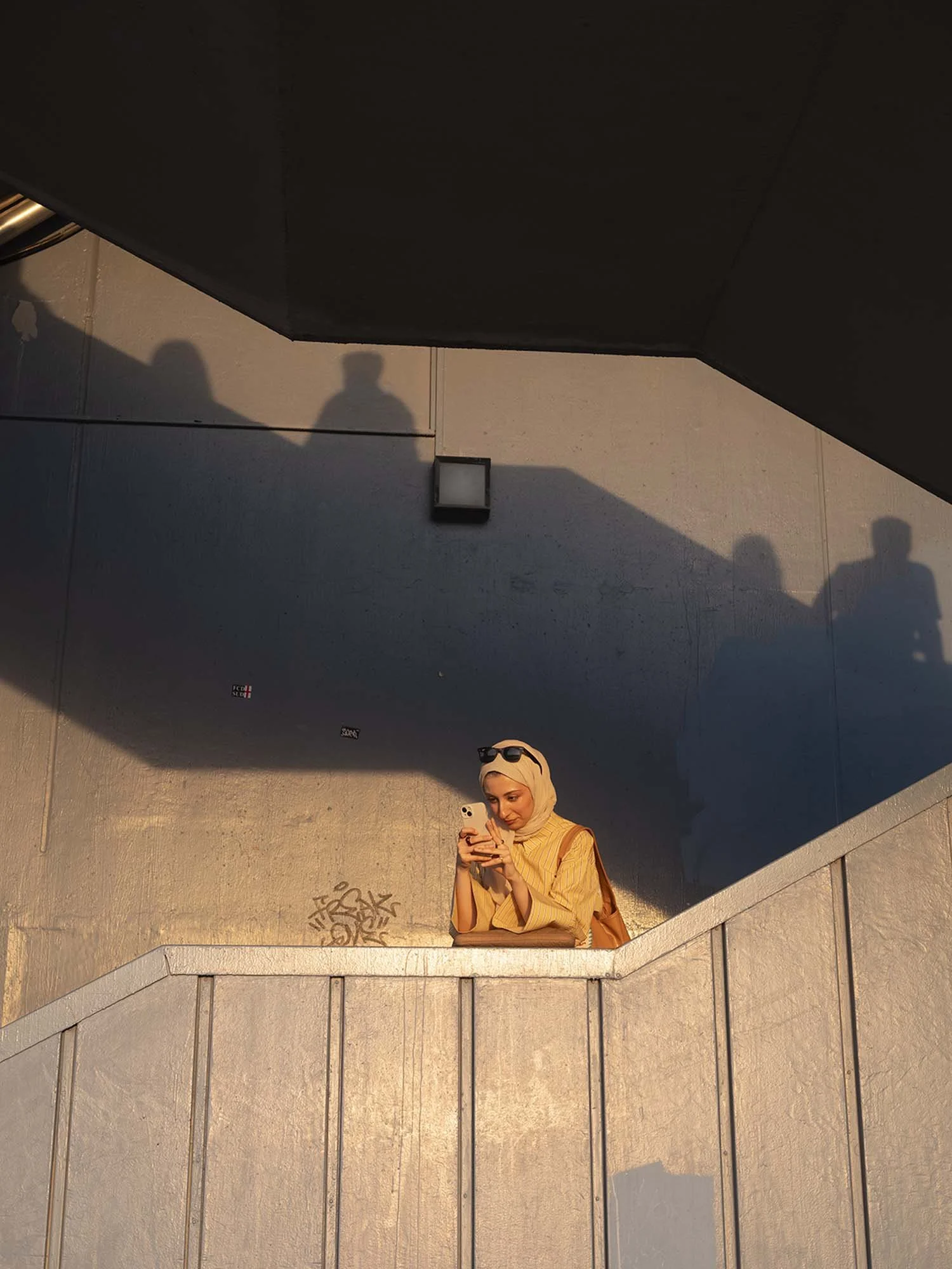 A bridesmaid under the Galata Bridge in Istanbul captured in a documentary photography style by Roman Bezjak
