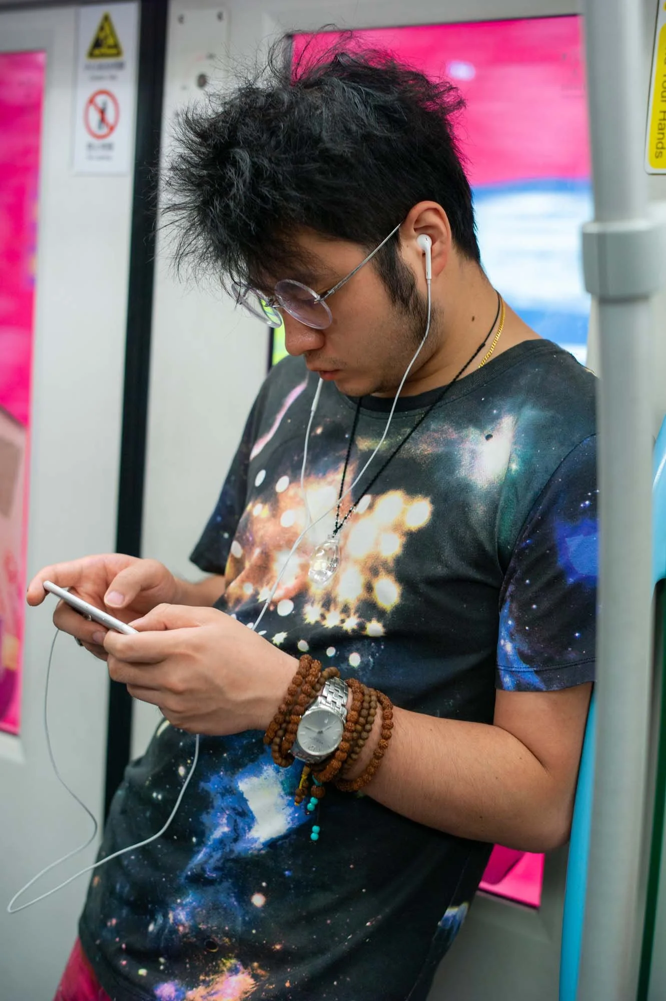 Submerged in thought, passengers in a Shanghai subway car gaze into their smartphones, photographed by Roman Bezjak