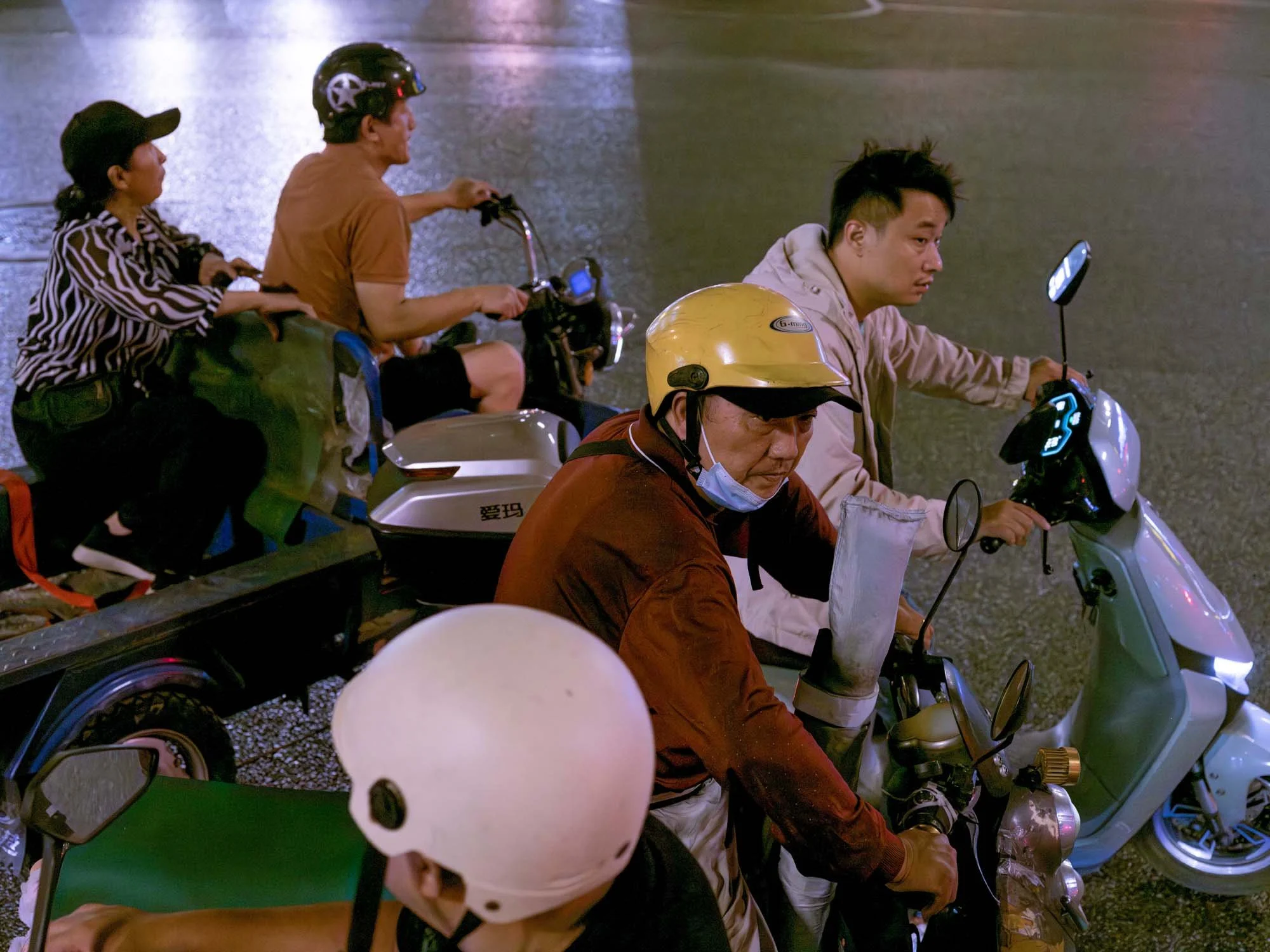 Documentary photograph by Roman Bezjak highlighting Shenzhen as a global leader in e-mobility, showing residents, families, and delivery workers navigating the city on electric scooters.