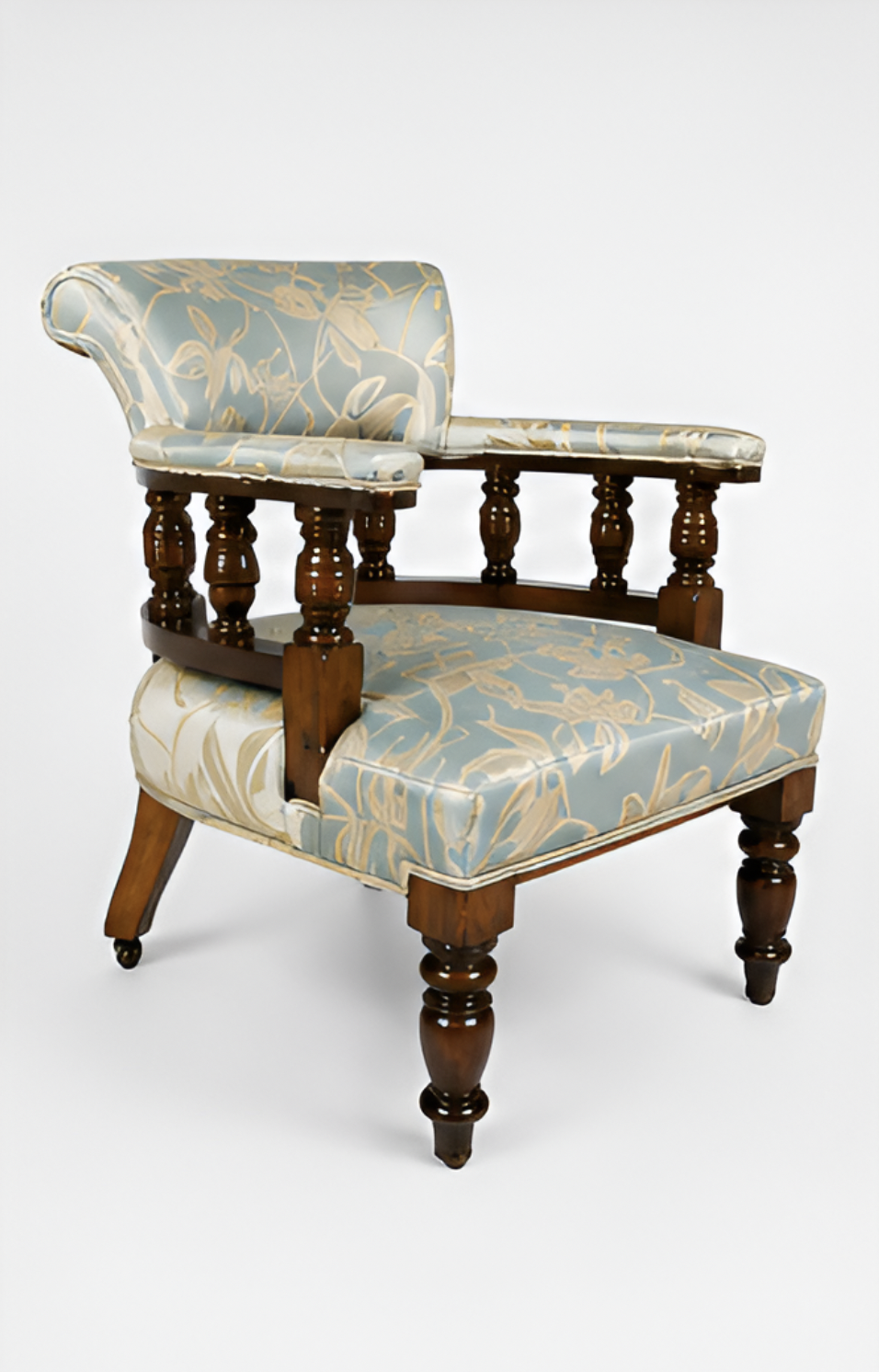 An antique wooden chair with intricate turned legs and a floral patterned upholstered seat and backrest.