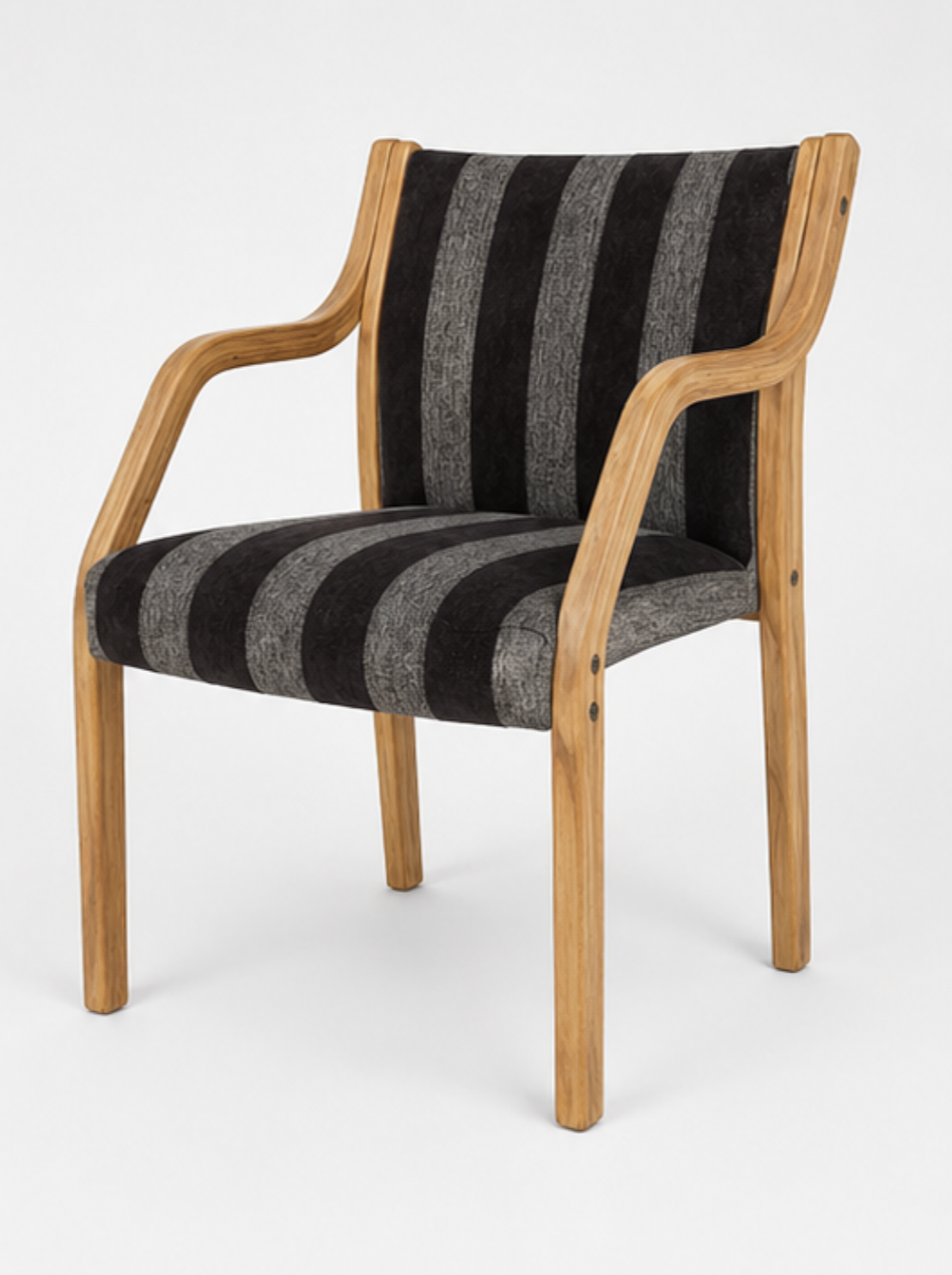 A wooden armchair with a striped black and gray cushion.