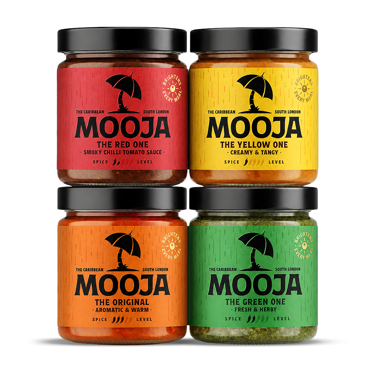 Four jars of Mooja Caribbean sauces with colorful labels: red labeled 'The Red One', yellow labeled 'The Yellow One', orange labeled 'The Original', and green labeled 'The Green One', each with black lids and a black umbrella logo.