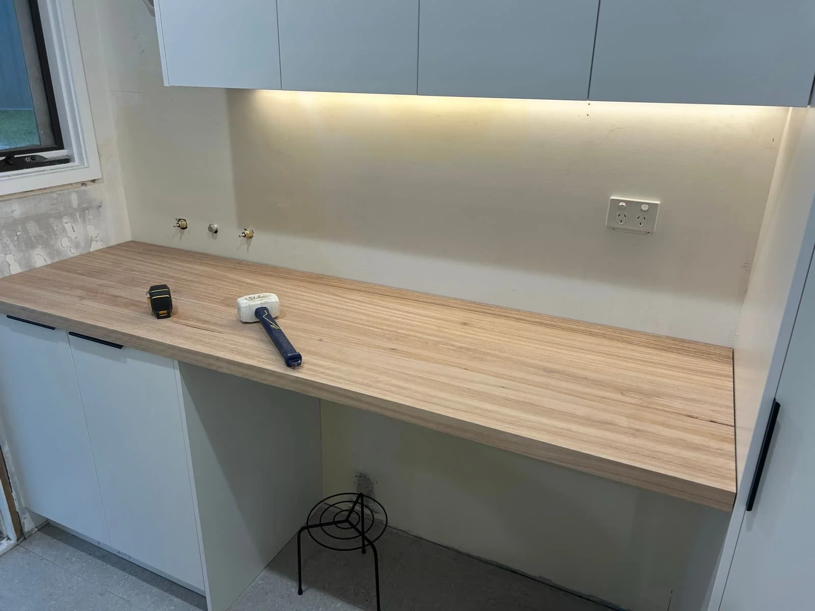 A custom hardwood benchtop installed in a laundry providing a sleek and modern finish to a functional space.