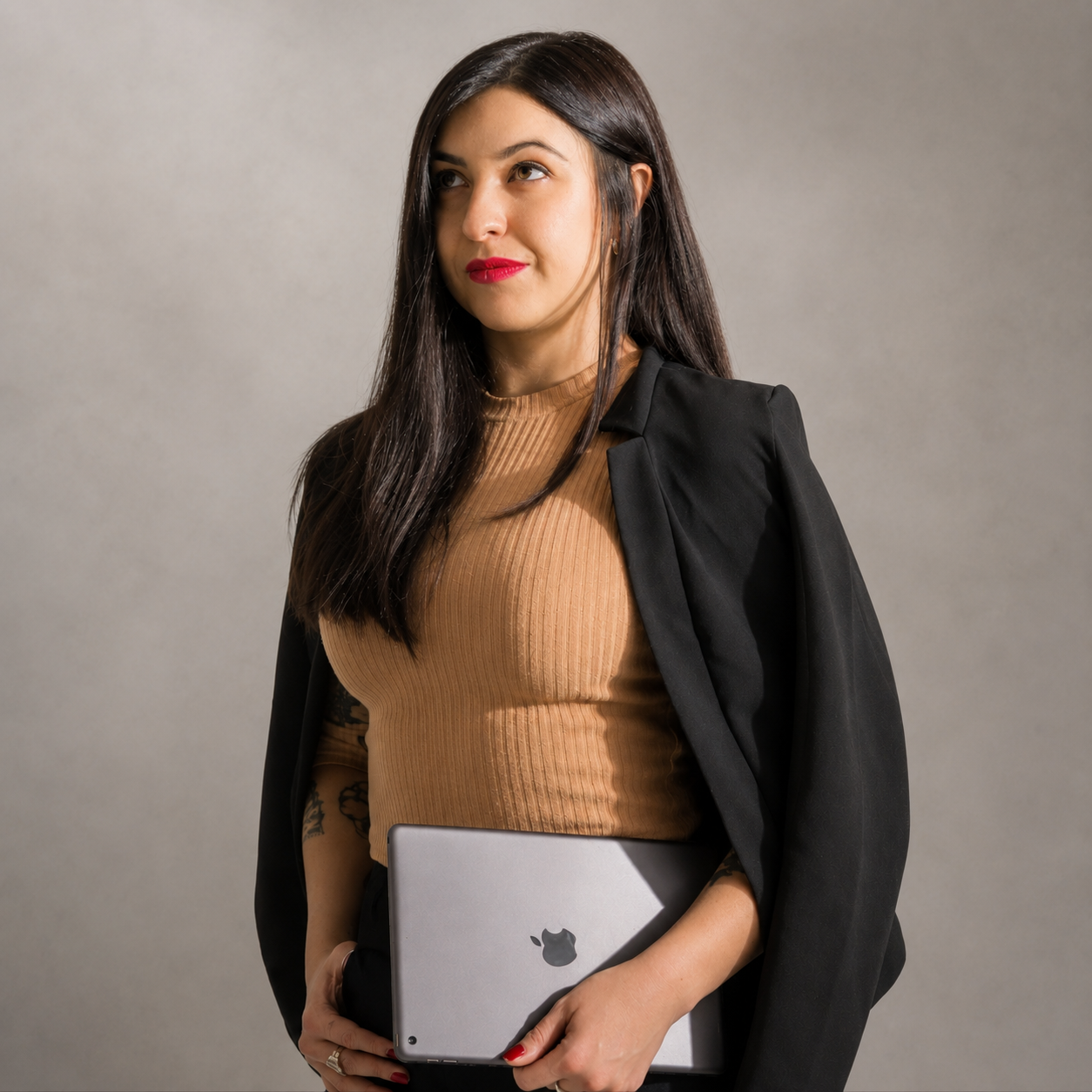 Consultora de marketing digital y branding sosteniendo un iPad durante una sesión fotográfica profesional.