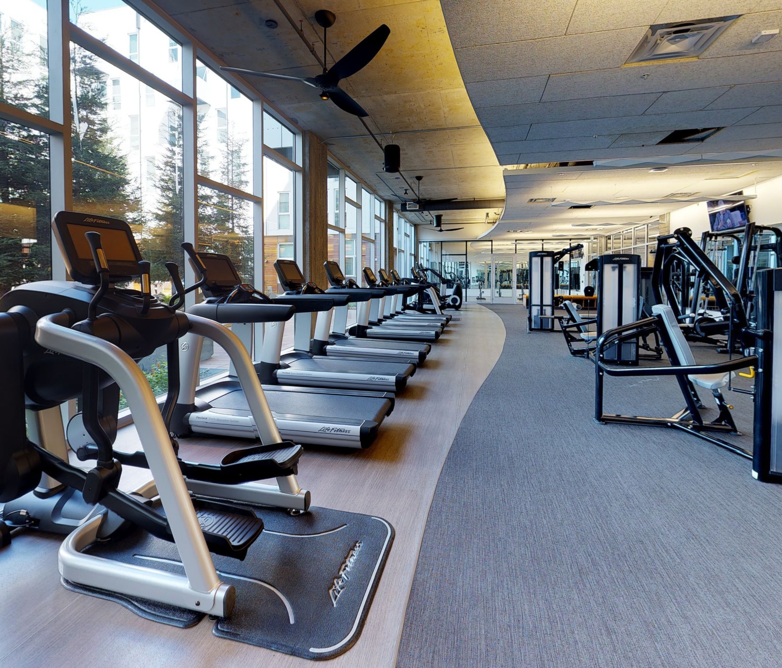 Empty modern gym with treadmills and exercise equipment, illustrating the hidden long-term cost of unused gym memberships in retirement planning.