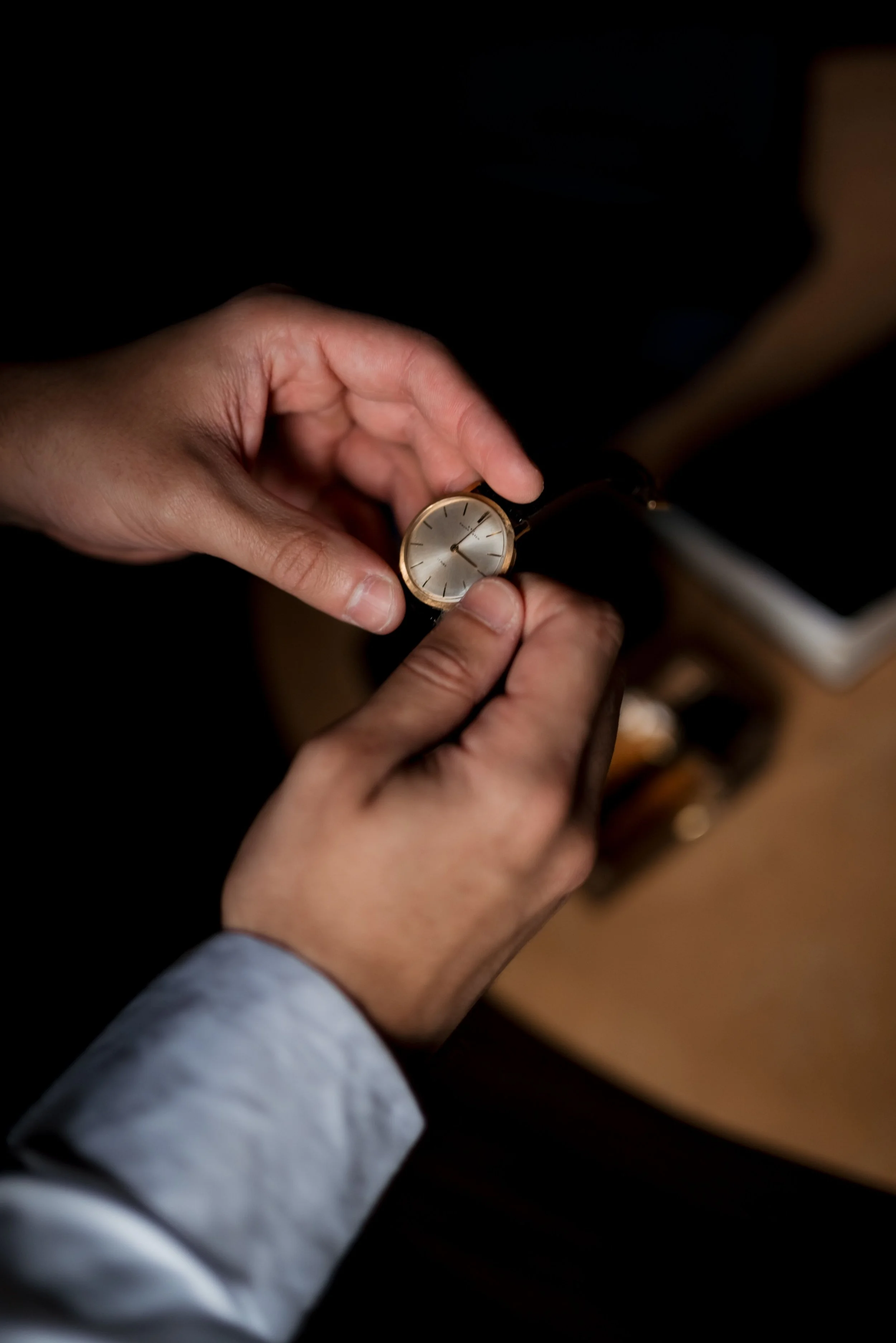 Wrist watch in someone's hands being wound or examined
