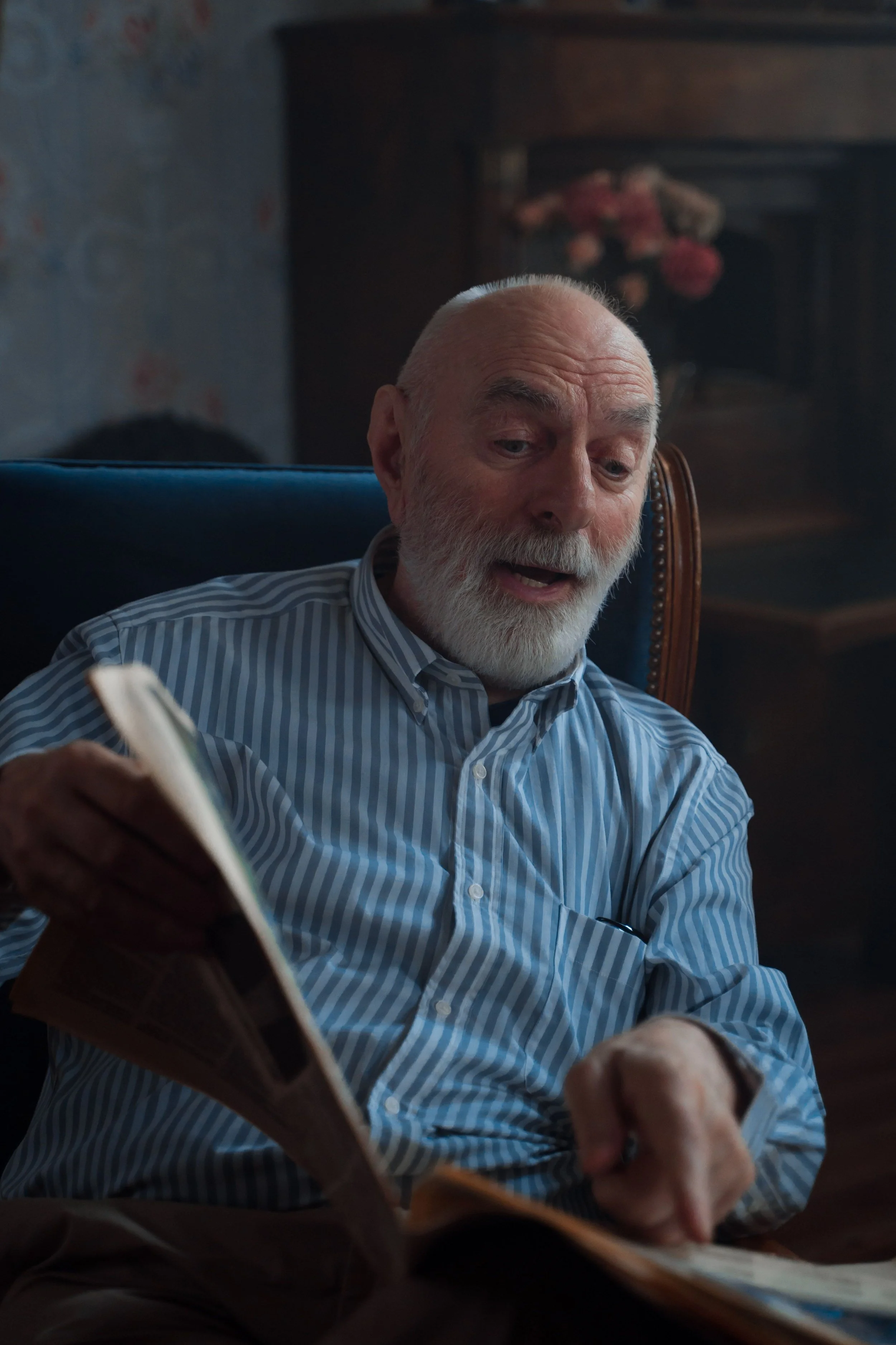 Older man looking through a family photo album.