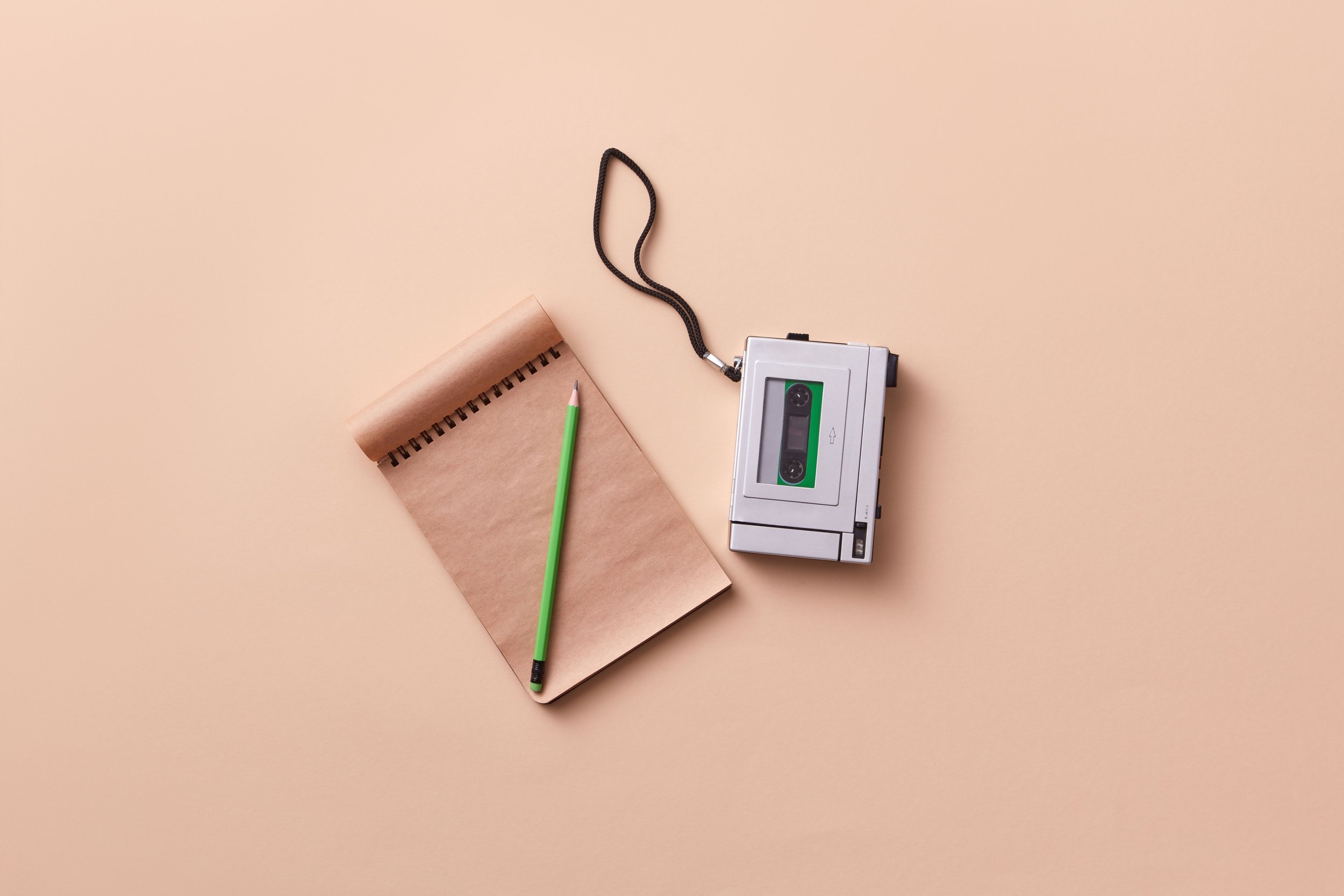 Notebook and digital audio recorder ready for an interview.