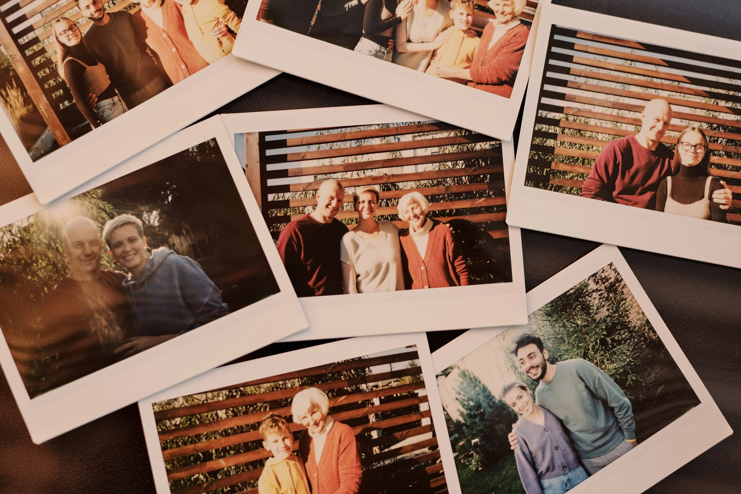 Printed family photographs showing several generations together.