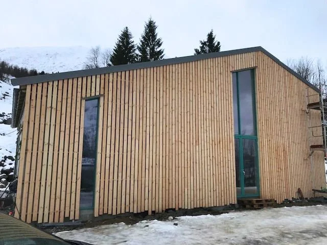 Timber building by Nordbadstu in a snowy Nordic setting