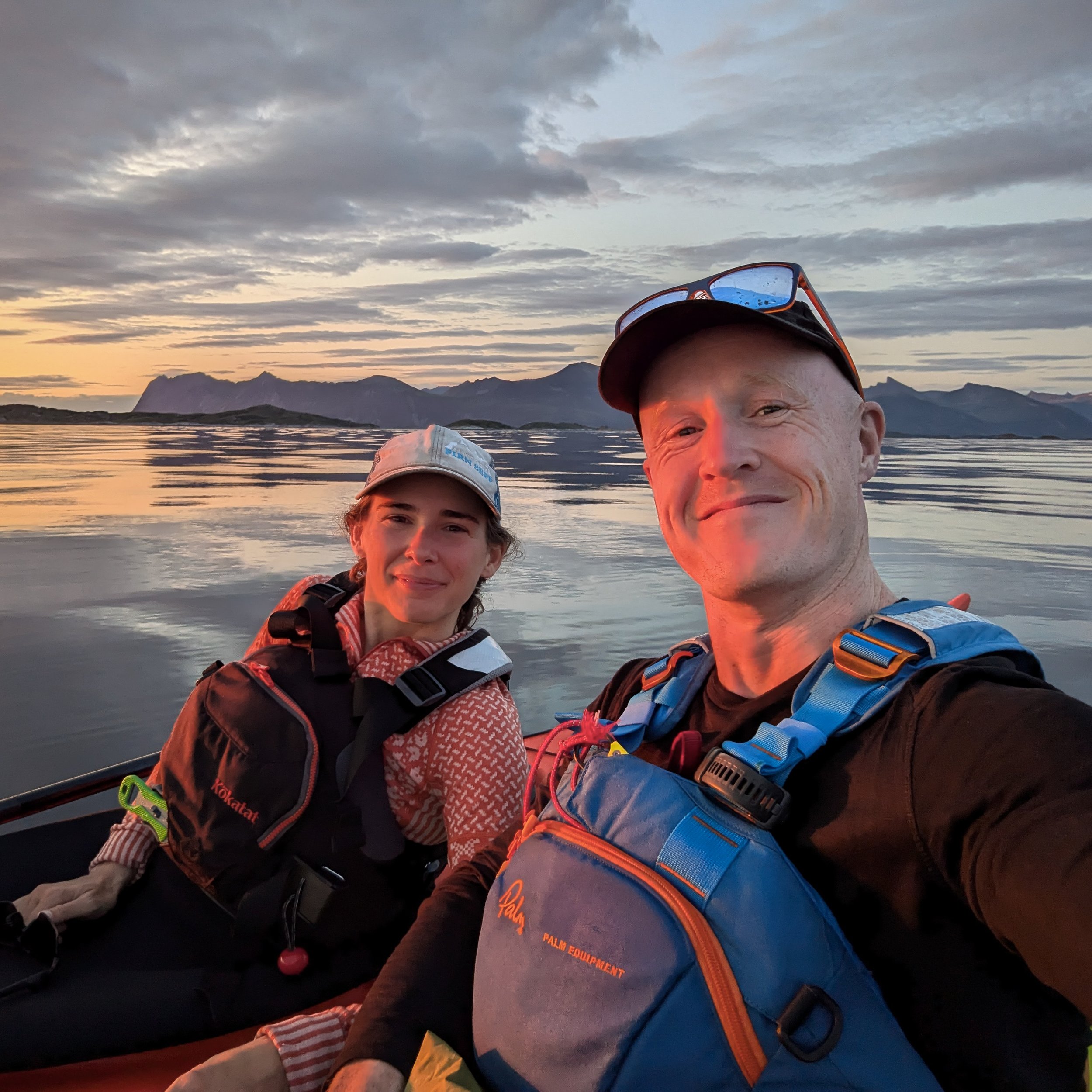 Two kayakers in the glow of the midnight sun