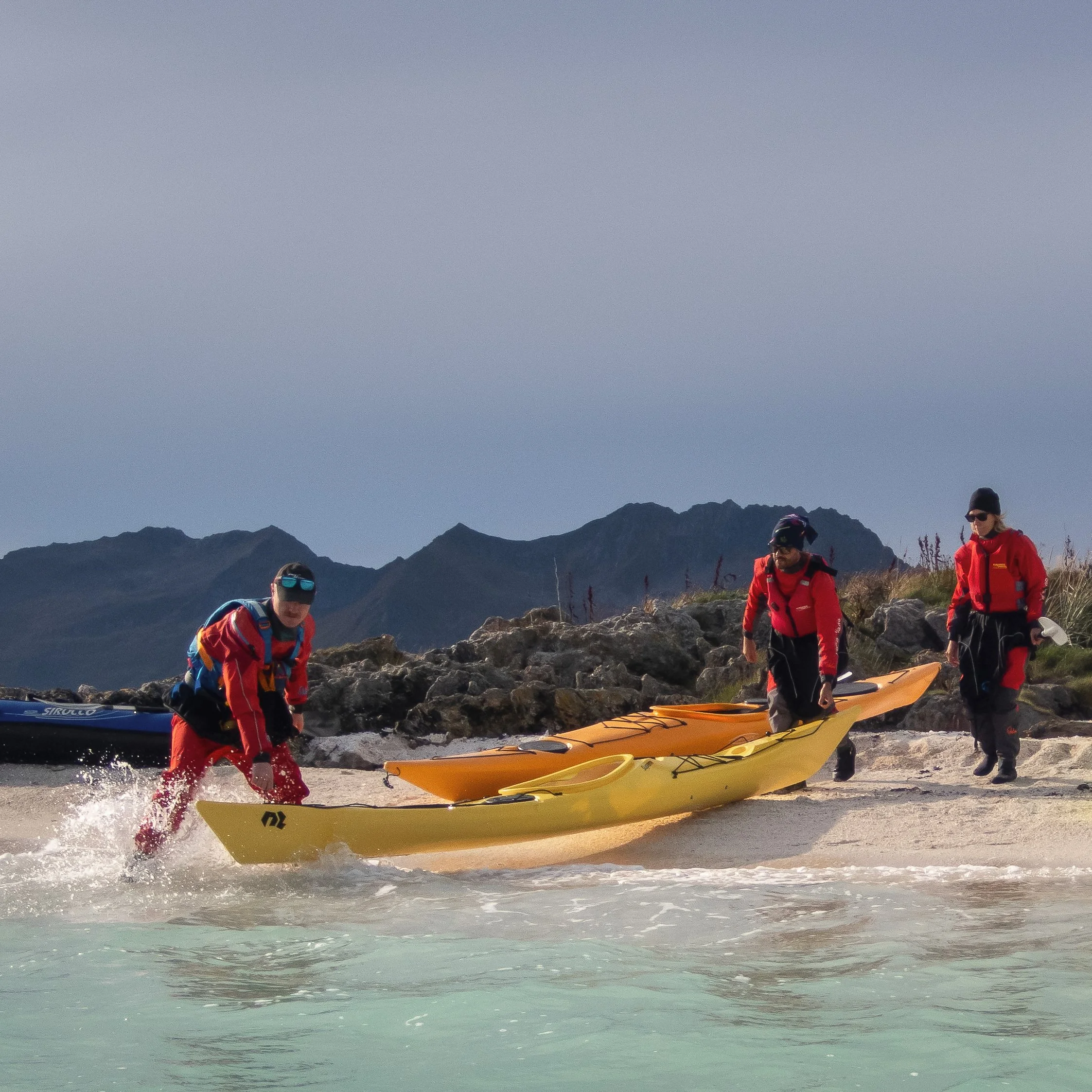 Kayak launch from a white-sand beach