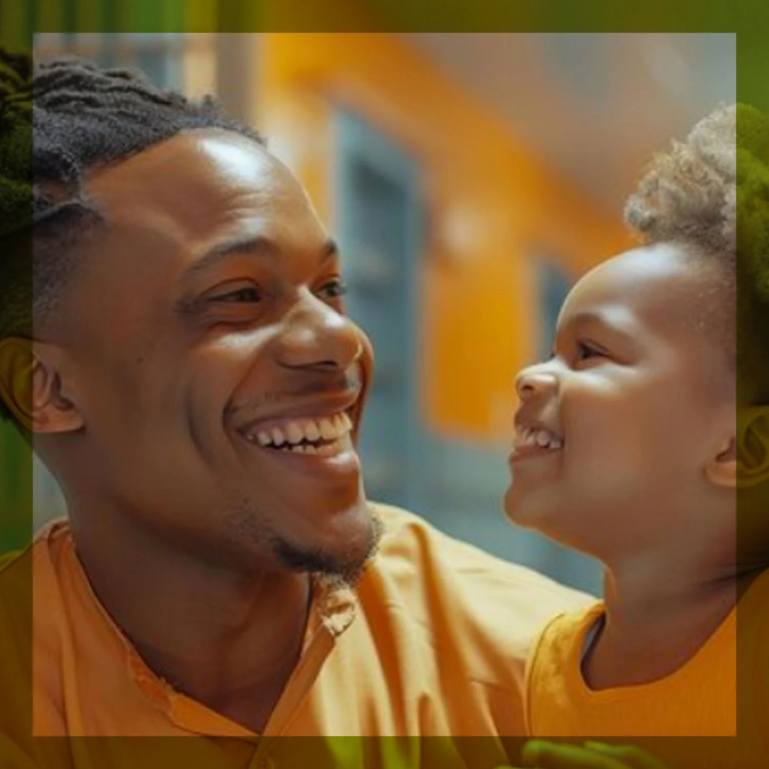 A man and a young boy are smiling at each other, both wearing orange shirts, in an indoor setting.