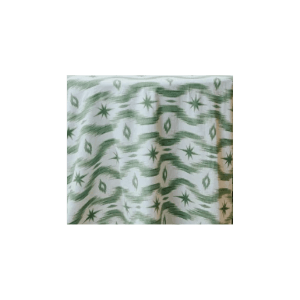 A fabric with green and white geometric patterns, including star shapes and diamond outlines.