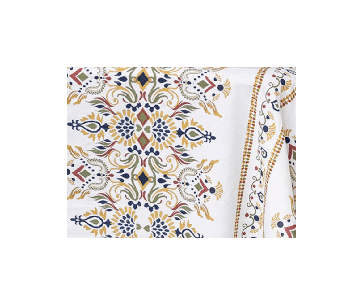 Close-up of a white fabric with intricate floral and geometric embroidery in yellow, navy blue, red, and green colors.