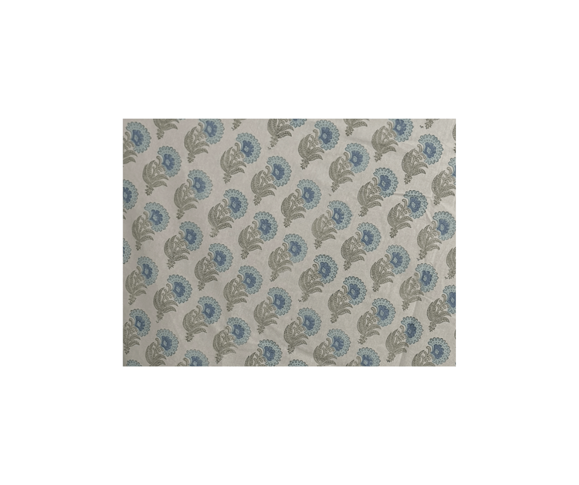 Close-up of a fabric with a repeating floral pattern in blue and gray on a light background.