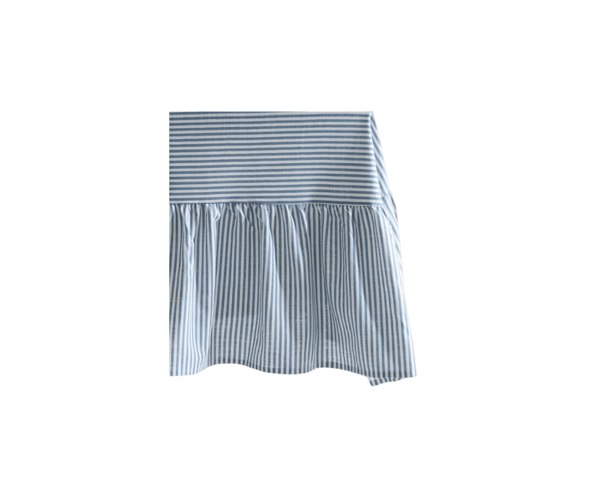 A piece of blue and white striped fabric with a gathered ruffle at the bottom.