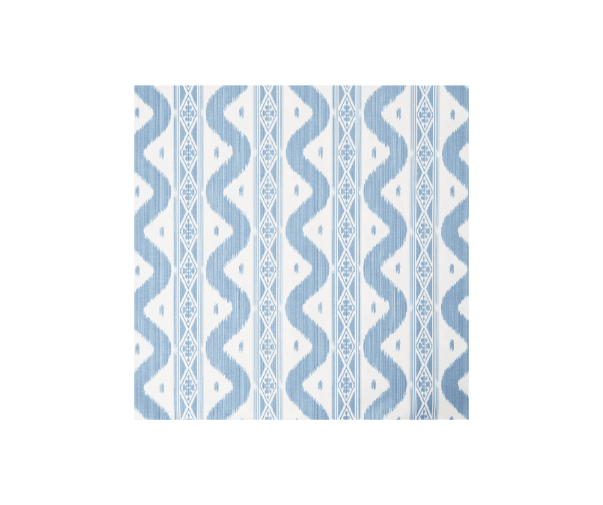Close-up of a light blue and white woven fabric with a geometric tribal pattern.