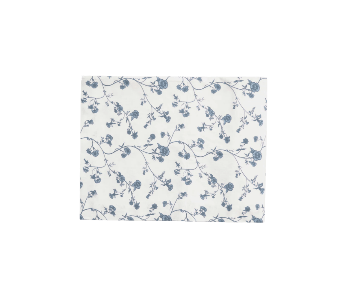 Square piece of fabric with a white background and a blue floral pattern of small flowers and vines.