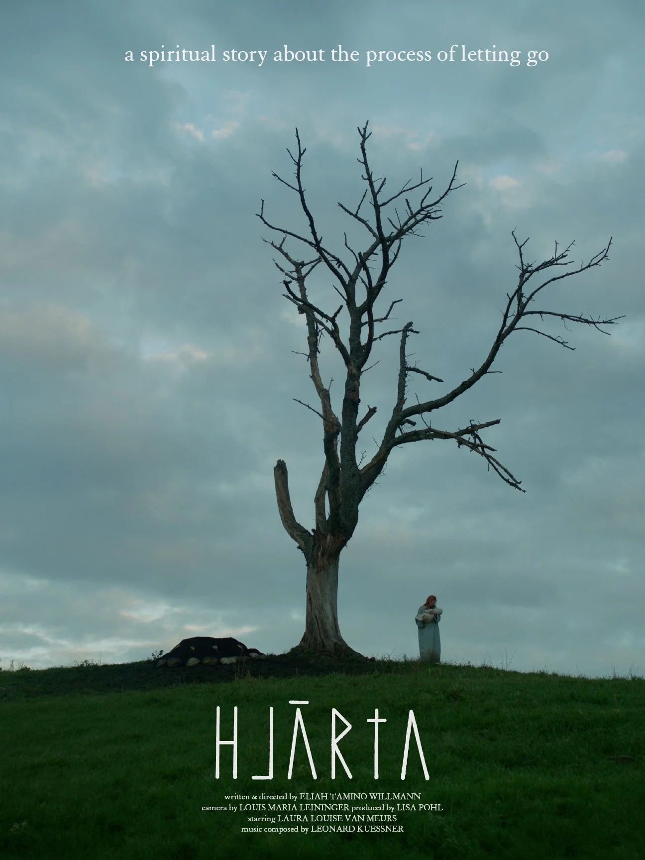 A person stands next to a tall, leafless tree on a grassy hill under a cloudy sky. The words 'a spiritual story about the process of letting go' are written at the top, and the title 'HJARTA' is below, along with credits for the creator, cast, and crew.