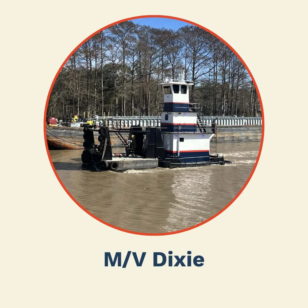 A tugboat named M/V Dixie navigating a river with a forested shoreline in the background.