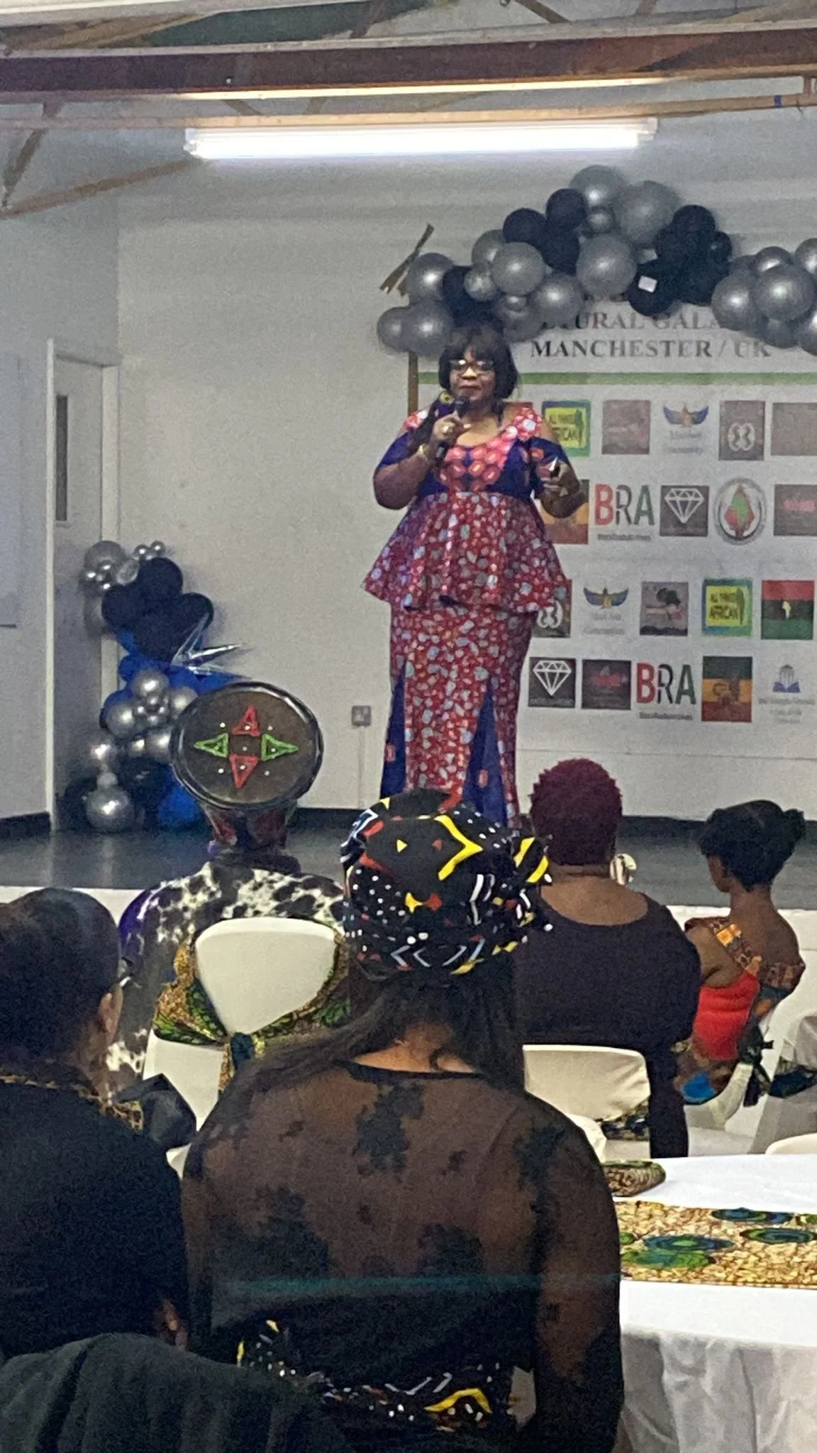 Adelaide Tatchemo delivering a keynote talk to a community audience in Manchester