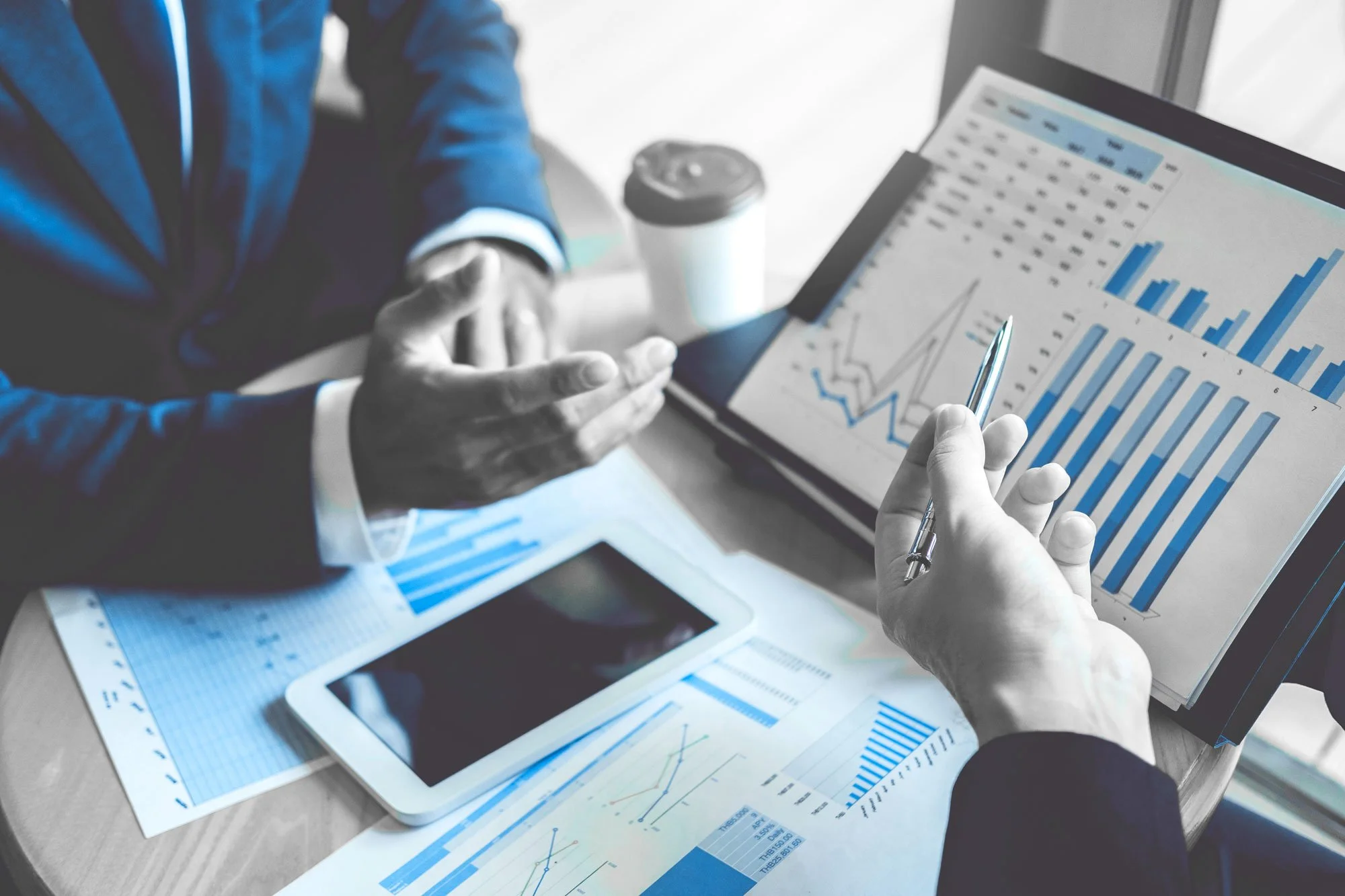 Financial advisor reviewing charts for tax-advantaged investing strategies.