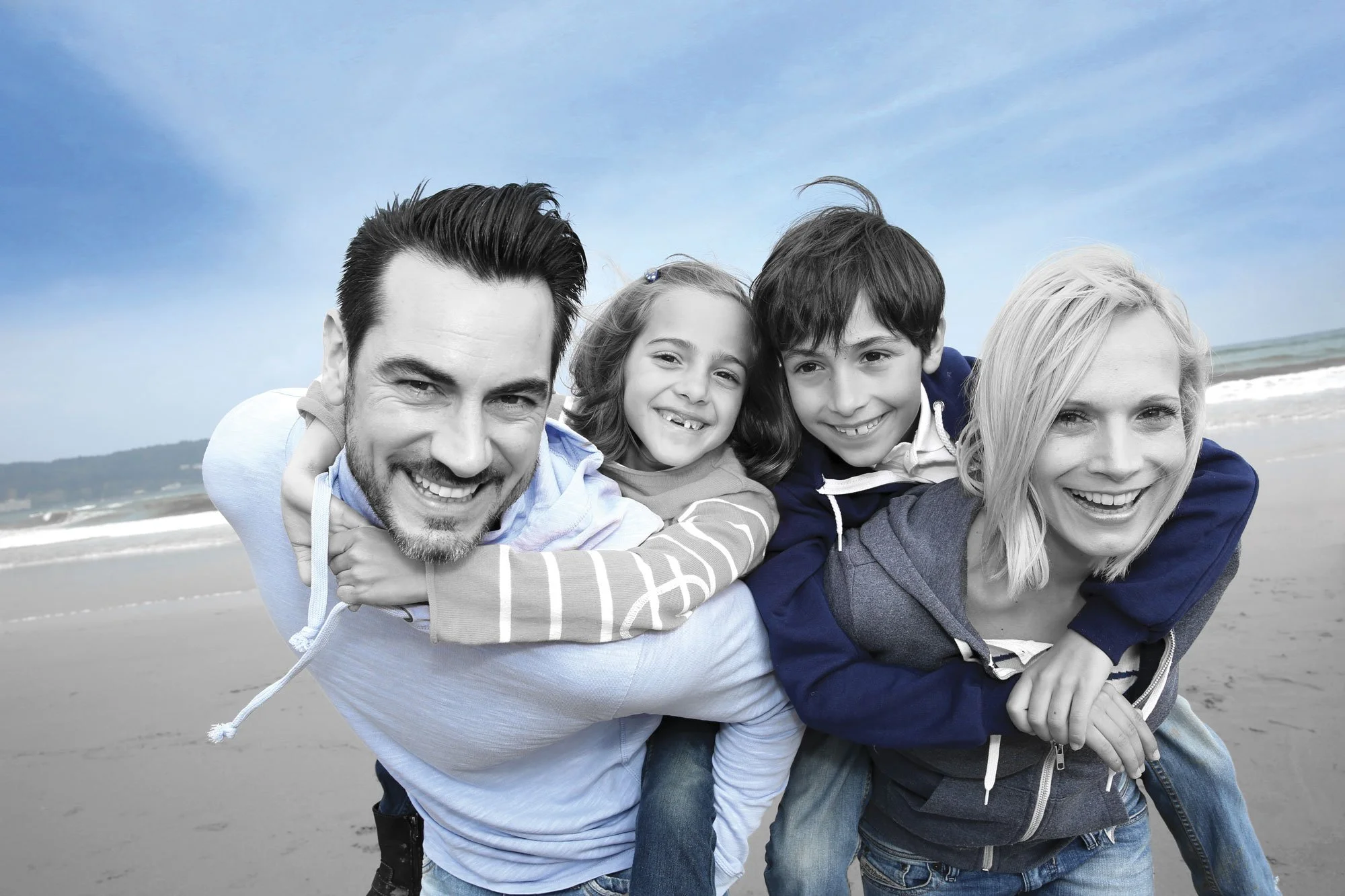 Family on the beach representing managed assets and long-term financial planning.