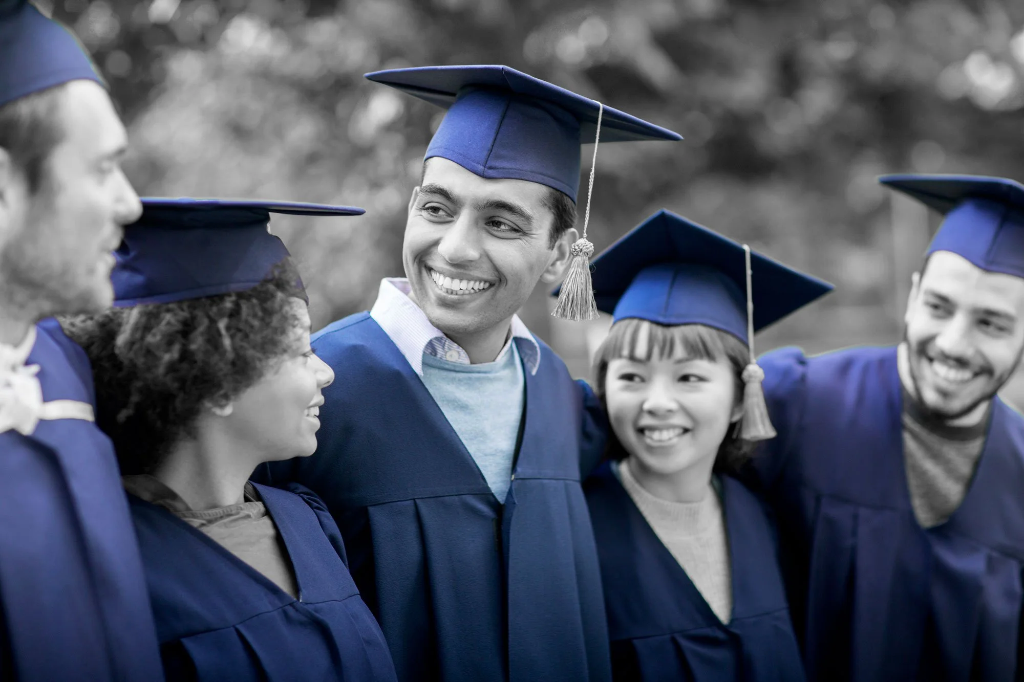 College graduates celebrating education funded through 529 plan investing.