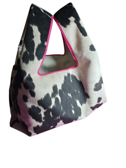 Black and white handbag with a pink-bordered triangular cutout handle.
