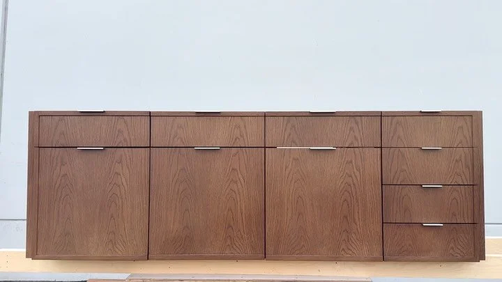 Crafted in plain-sliced white oak with a timeless warm finish and clean proportions. The refined border detailing, sleek hardware, and thoughtfully concealed pull-outs come together in this custom cabinetry &mdash; designed to make organization look 