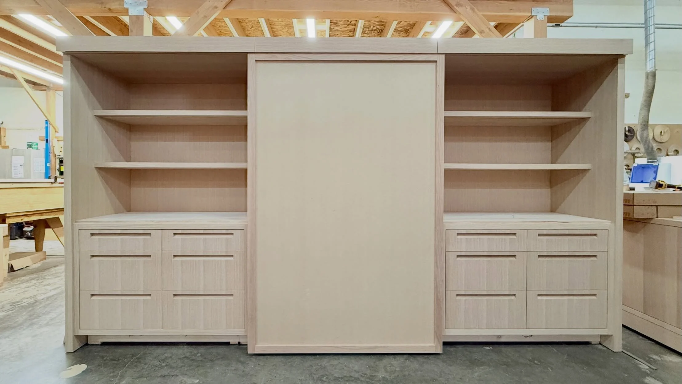 Behind every beautifully organized space is exceptional craftsmanship.

This custom closet is taking shape with dedicated hanging storage, drawer organization, and open display shelving. Headed to the next stage with stone countertops and sleek slidi