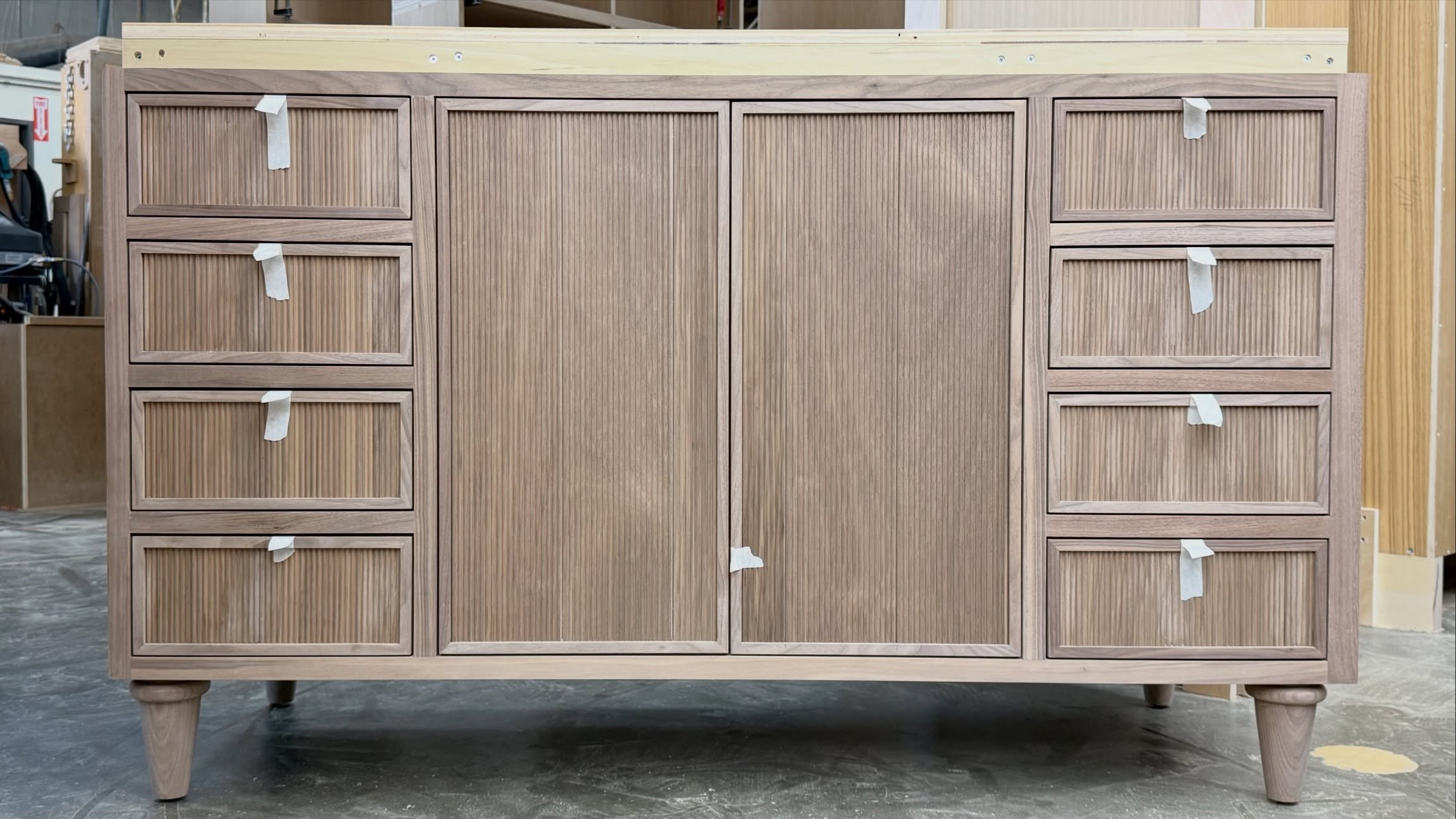 Walnut Vanity with reeded fronts, complete with turned feet that gives this vanity a furniture-like feel. 

Next stop: Finishing, then a stone top to complete the look. 

#CustomCabinetry #WalnutCabinets #ReededWood #CustomVanity #Woodworking