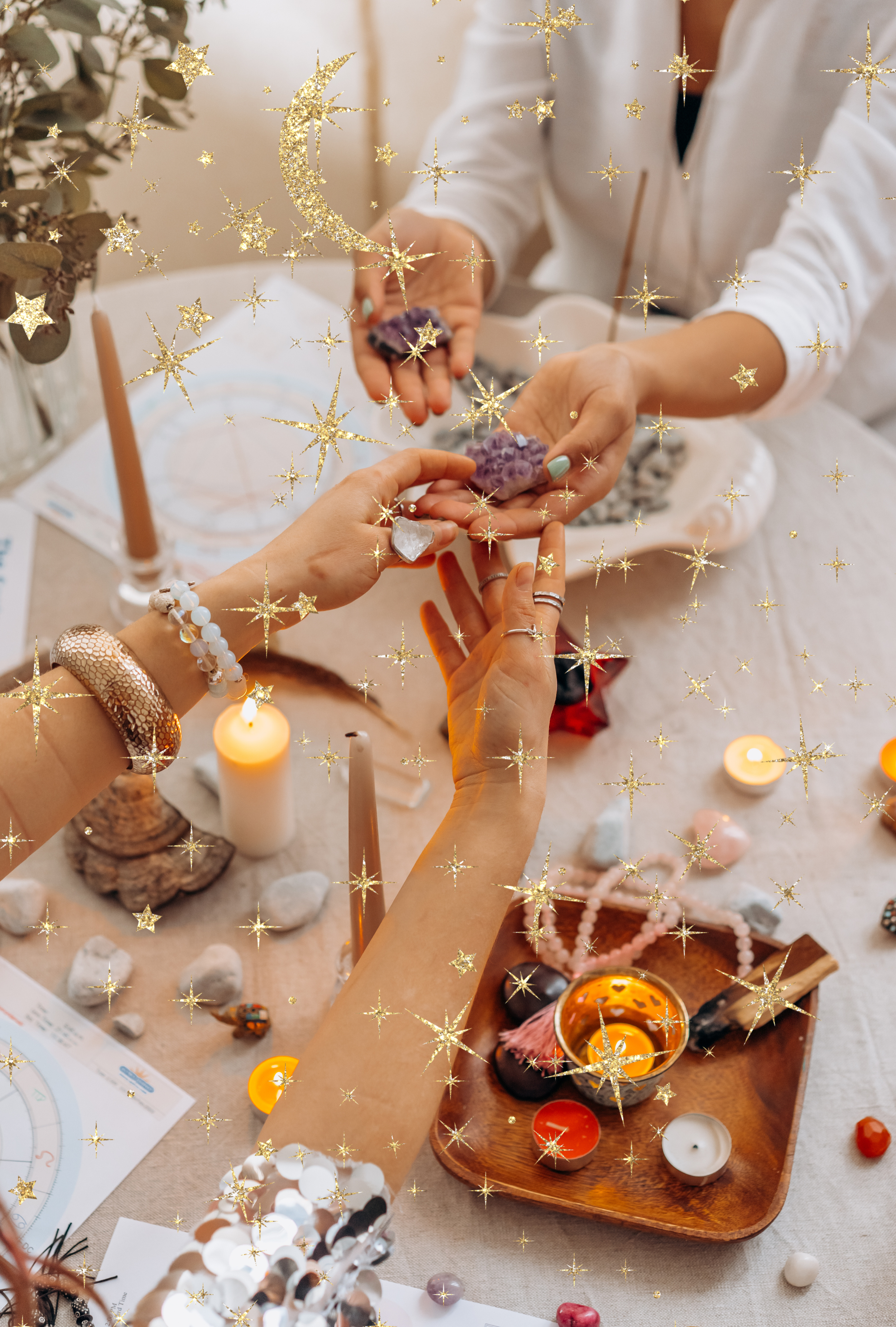 People handling crystals or gemstones at a table decorated with candles, jewelry, and decorative stones, with a star and moon holographic decoration overlay.