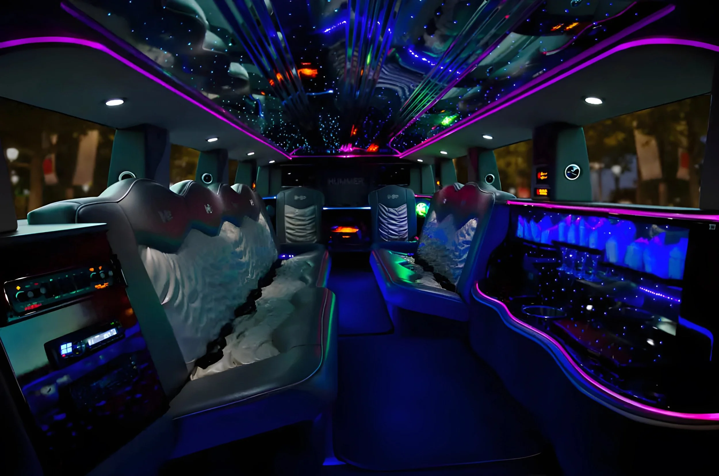 Inside a luxury vehicle with illuminated interior, neon purple and blue lighting, star-like ceiling lights, leather seats, and a control panel.