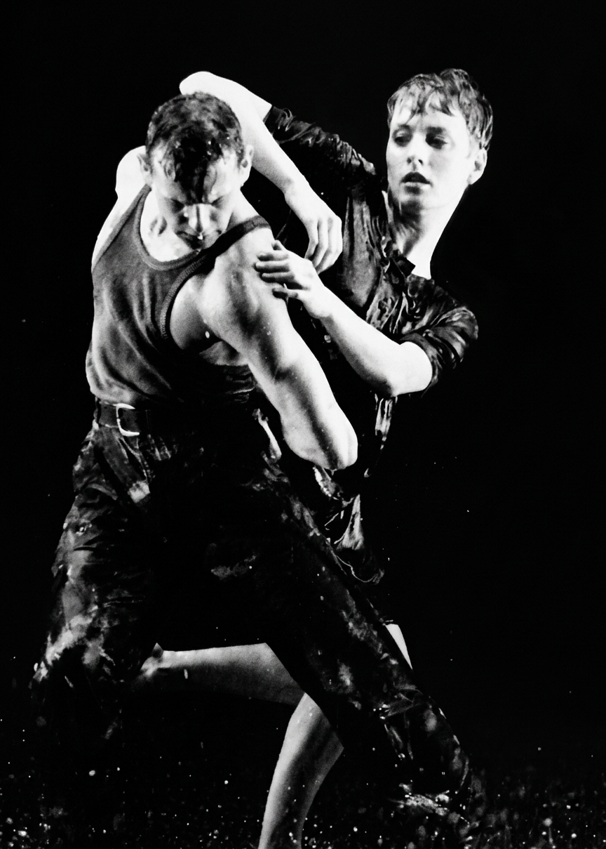 Two people engaged in a physical confrontation or dance, with one person grabbing the other's upper arm while the other appears distressed or defensive.