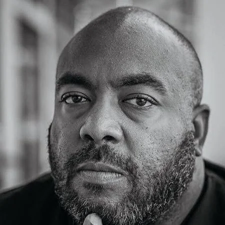 A close-up of the platform's founder, Shawn Taylor. This is a photo that his friends jokingly call, "the headshot of a bouncer" or, "have you ever smiled?"